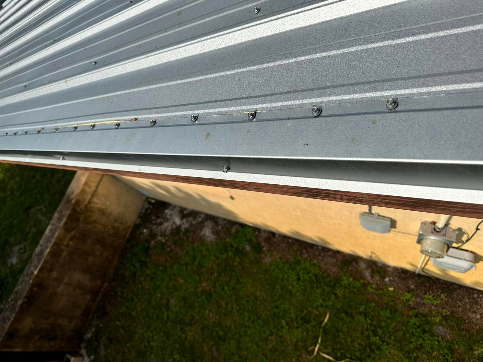 Close-up of screws and trim along the edge of a new metal roof