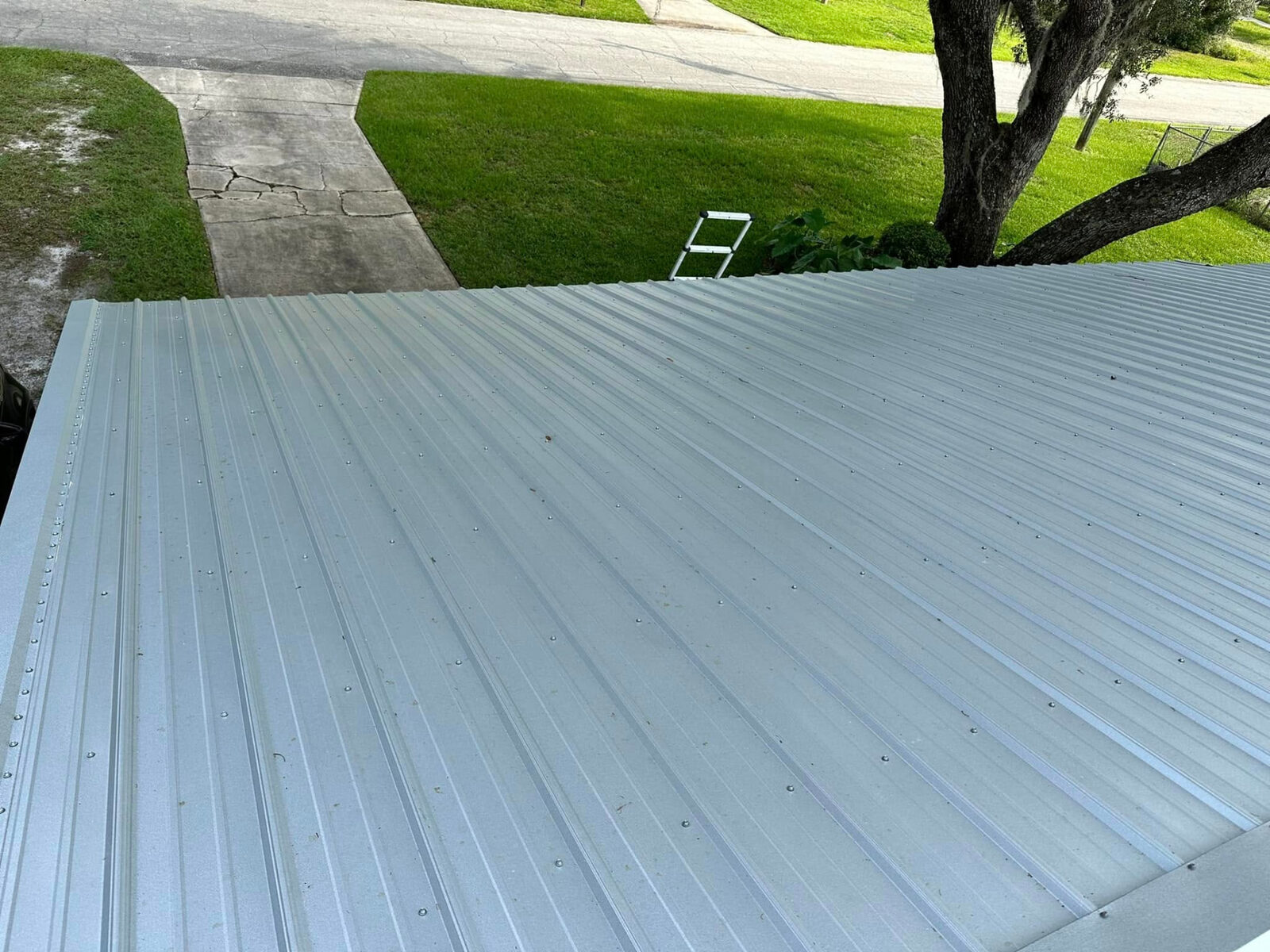 Front slope of a new metal roof facing the driveway