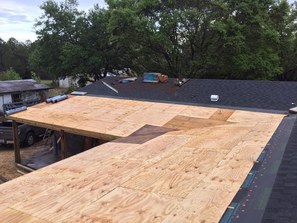 Fresh plywood decking installed over a home addition before underlayment
