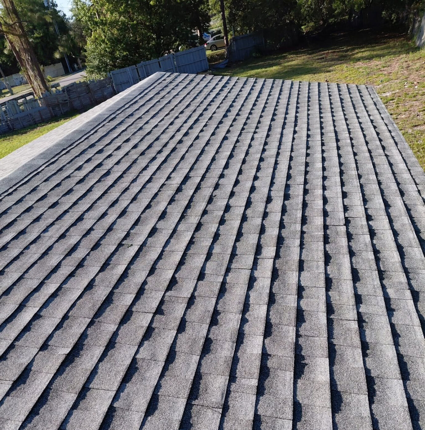 Long run of new gray shingles on a single-story Orlando home